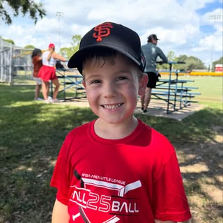 I sure hope baseball sticks because he looks pretty cute in a hat and catchers gear!