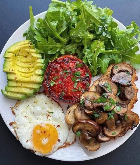 A colorful and healthy breakfast plate 🌱🍳🥑 — featuring fried egg, creamy avocado, grilled tomato,