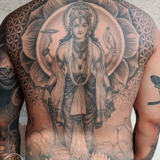 This tattoo showcases Maha Vishnu, the eternal guardian and protector, etched with intricate detail 