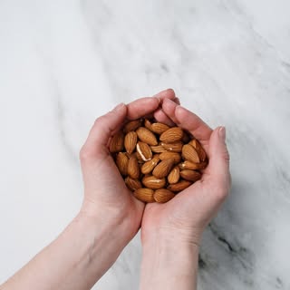 Incorporating nuts into your diet can help stimulate hair growth as they contain ample amounts of om