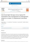 Low-level light therapy versus topical 5% minoxidil in the management of androgenetic alopecia in males: A randomised controlled trial